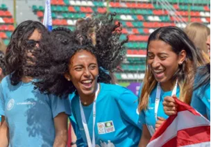 Women footballers with flag